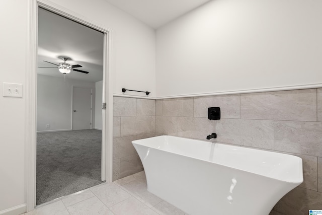 bathroom featuring a tub, ceiling fan, and tile patterned flooring