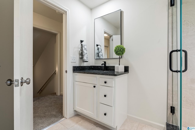 bathroom featuring tile patterned floors, an enclosed shower, and vanity