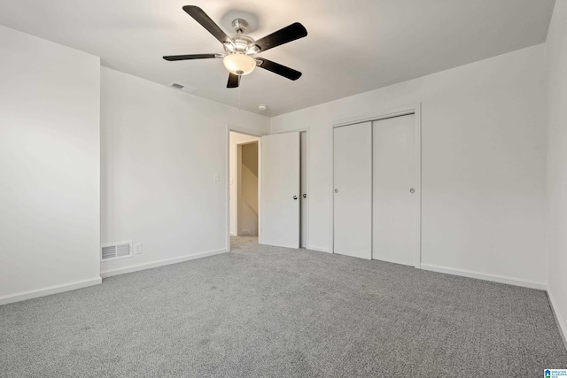 unfurnished bedroom featuring ceiling fan, a closet, and carpet floors