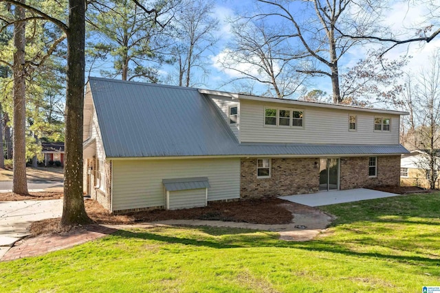 back of house featuring a lawn and a patio