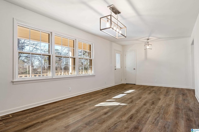 interior space featuring dark hardwood / wood-style floors and a notable chandelier