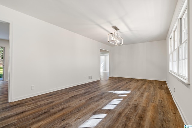 unfurnished dining area featuring dark wood-type flooring