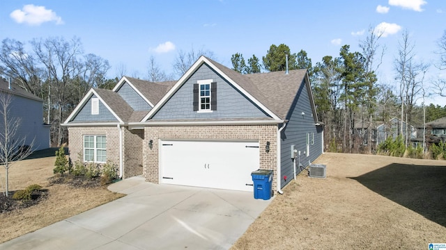 craftsman house featuring a garage and cooling unit