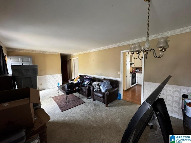 living room featuring carpet and a notable chandelier