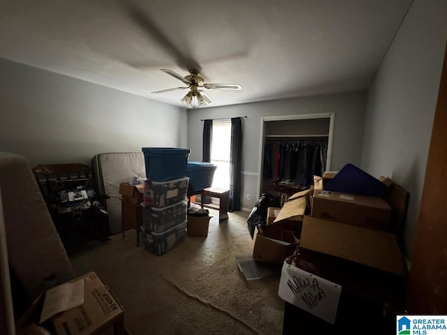 carpeted bedroom featuring ceiling fan and a closet