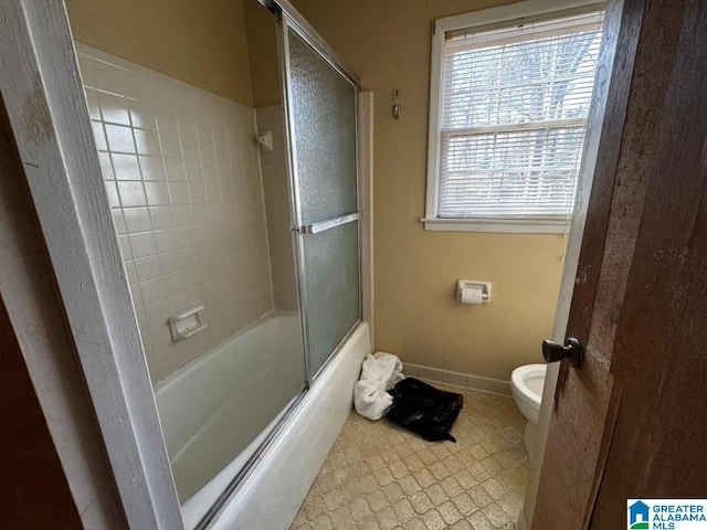 bathroom with toilet, tile patterned flooring, and enclosed tub / shower combo