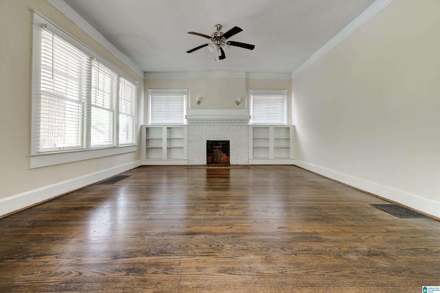 unfurnished living room with ceiling fan, a brick fireplace, crown molding, and dark hardwood / wood-style floors