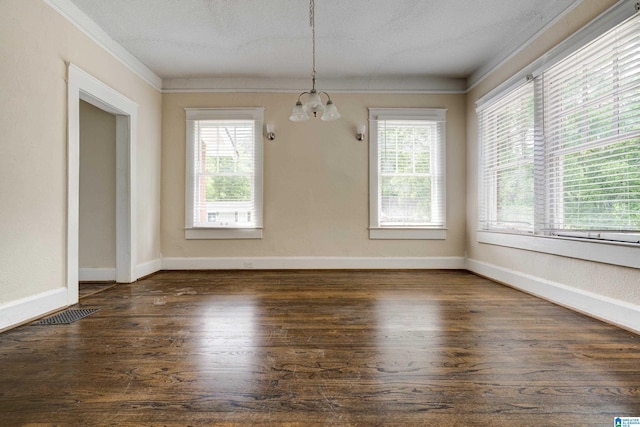 unfurnished dining area featuring a textured ceiling, dark hardwood / wood-style flooring, and crown molding