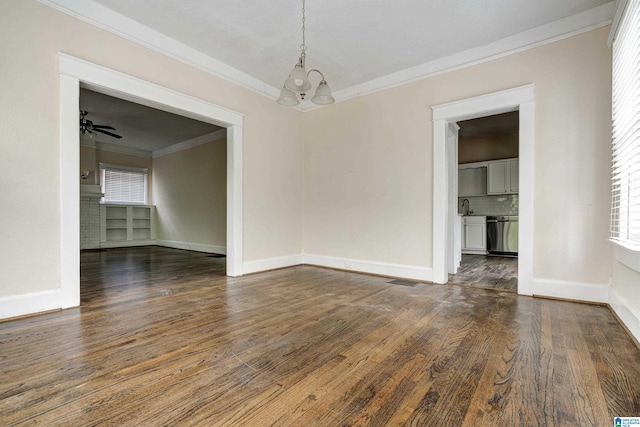 unfurnished dining area featuring dark wood-type flooring, ceiling fan with notable chandelier, and ornamental molding