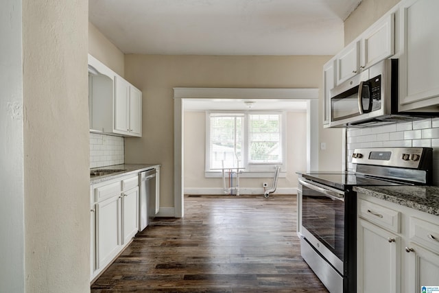 kitchen with white cabinets, decorative backsplash, appliances with stainless steel finishes, and light stone counters