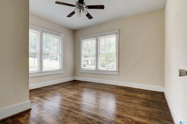 spare room featuring ceiling fan and dark wood-type flooring