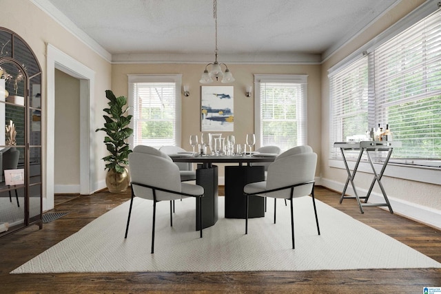 dining space featuring a textured ceiling, plenty of natural light, and dark hardwood / wood-style floors