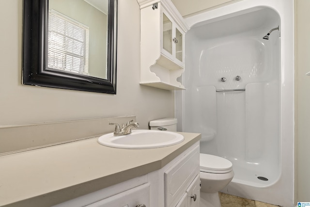 bathroom featuring toilet, a shower, tile patterned flooring, and vanity