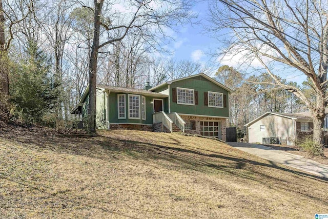 tri-level home with a front lawn and a garage