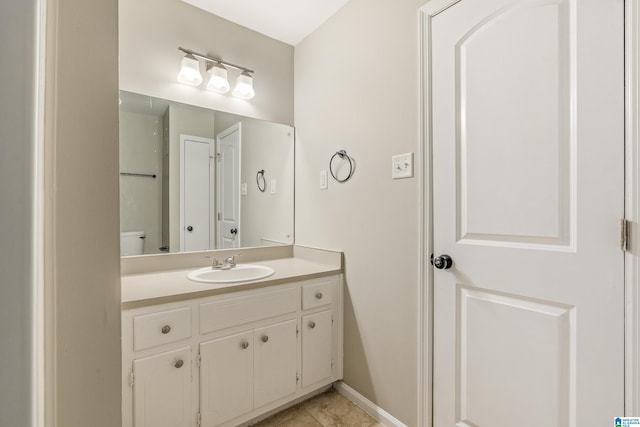 bathroom featuring toilet, tile patterned flooring, and vanity