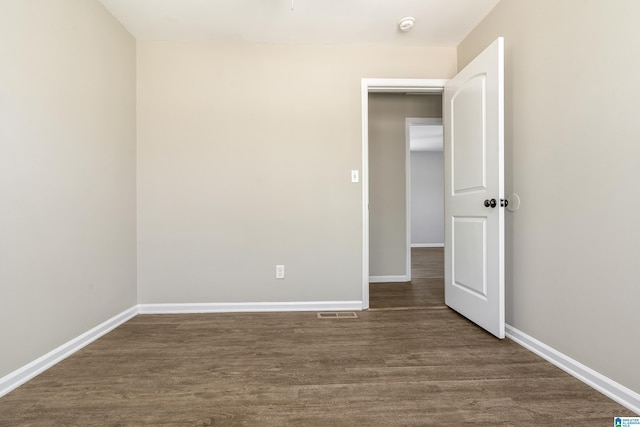 spare room with dark hardwood / wood-style flooring