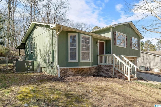 tri-level home with central AC and a front lawn