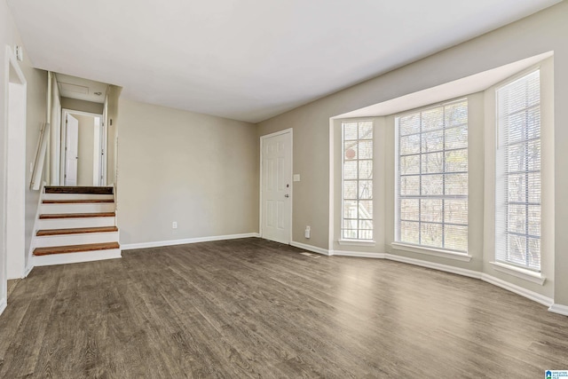 unfurnished living room featuring dark wood-type flooring