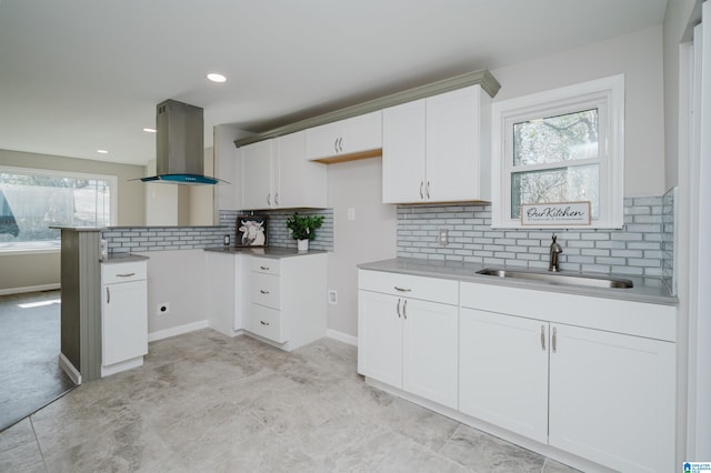 kitchen with sink, a wealth of natural light, white cabinets, and island exhaust hood