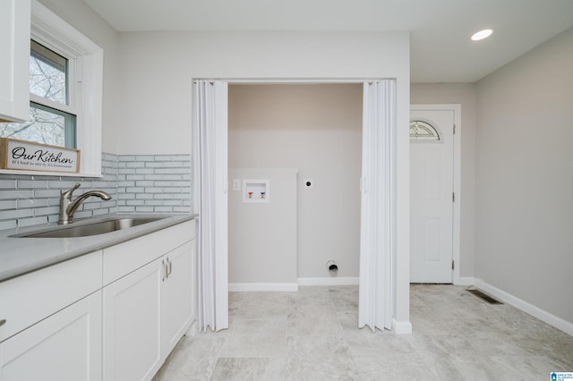 laundry area with hookup for a washing machine, sink, and electric dryer hookup