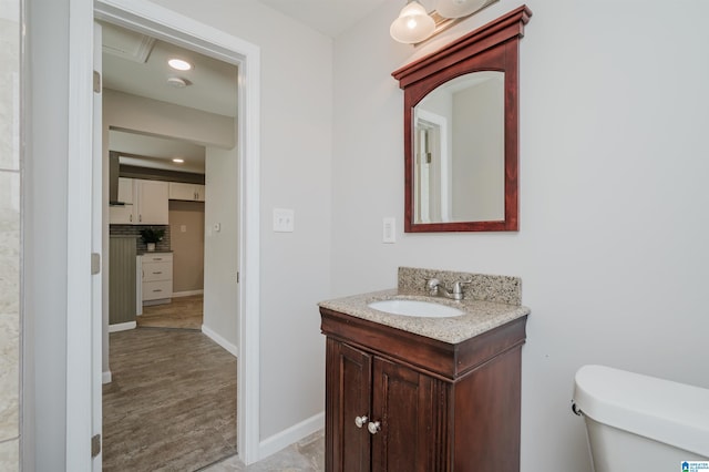 bathroom with decorative backsplash, toilet, and vanity