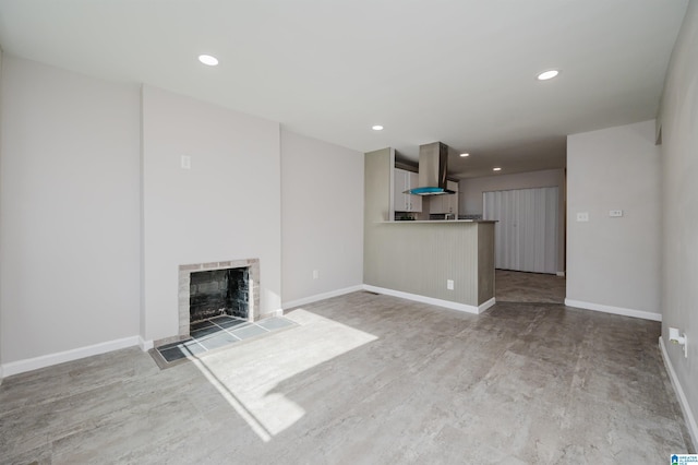 unfurnished living room featuring a tile fireplace