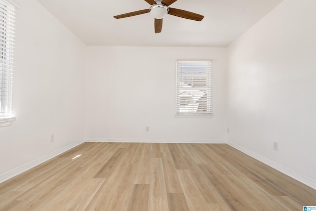 empty room with ceiling fan and light hardwood / wood-style floors