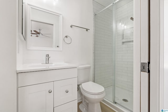 bathroom with ceiling fan, toilet, vanity, and walk in shower