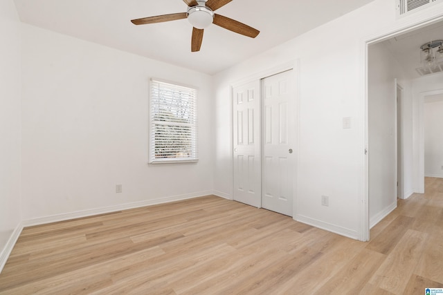 unfurnished bedroom with ceiling fan, a closet, and light wood-type flooring