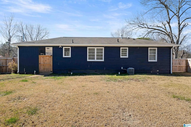 rear view of house featuring a yard