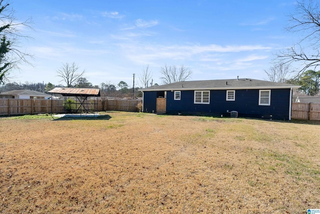 back of property with a gazebo and a yard