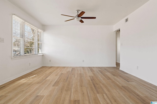 empty room with ceiling fan and light wood-type flooring