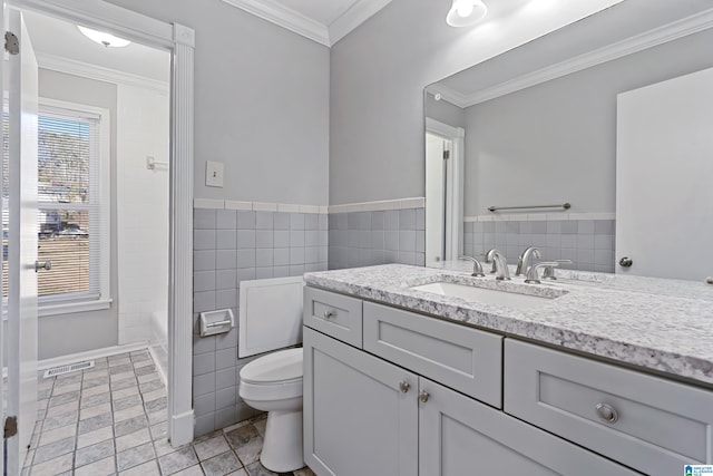 bathroom featuring tile walls, toilet, vanity, and crown molding