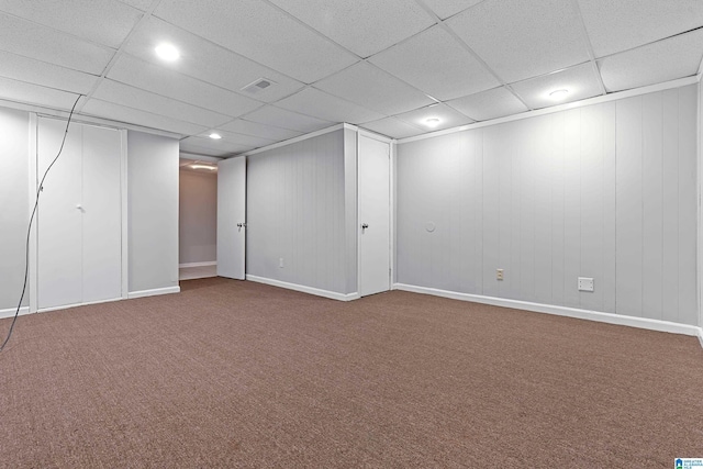 basement with carpet and a paneled ceiling