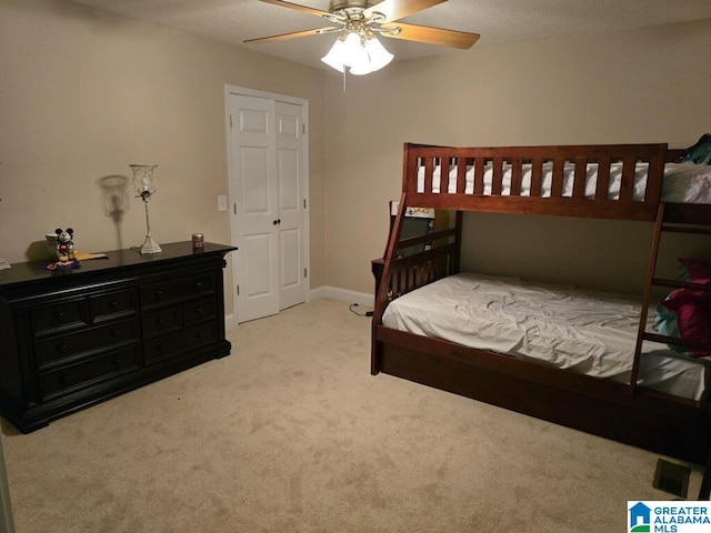 bedroom with ceiling fan and light carpet