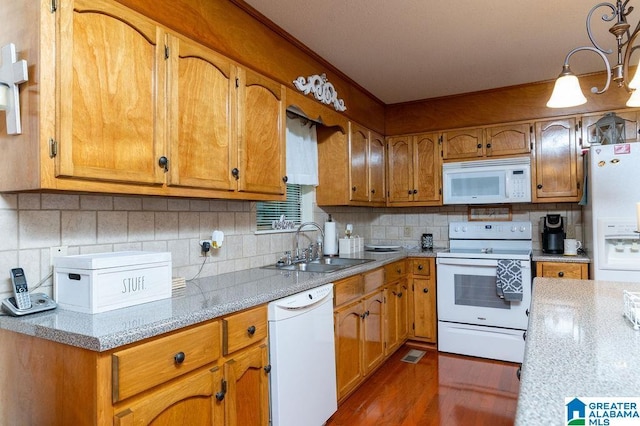 kitchen with decorative backsplash, sink, white appliances, dark hardwood / wood-style flooring, and light stone counters