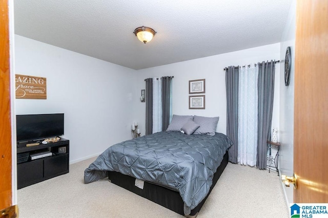 bedroom with a textured ceiling and carpet