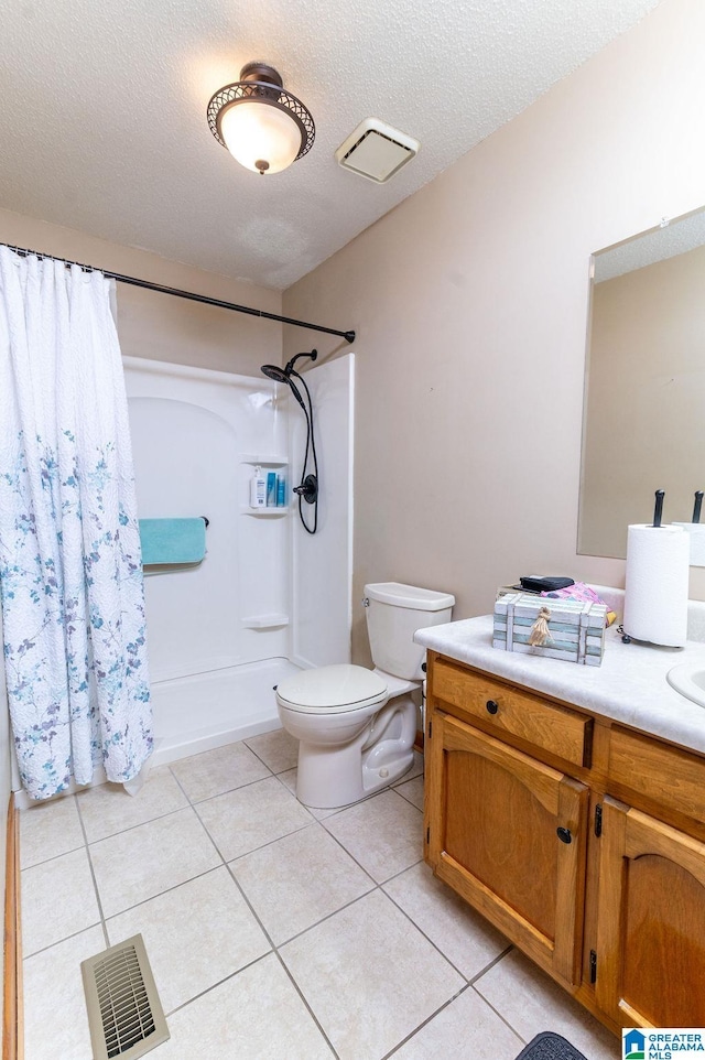 bathroom with a textured ceiling, tile patterned floors, vanity, a shower with curtain, and toilet