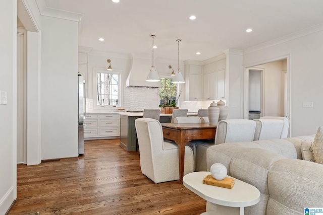 dining room featuring crown molding and dark hardwood / wood-style floors