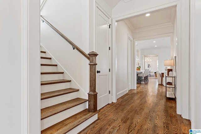 entrance foyer with ornamental molding and dark wood-type flooring