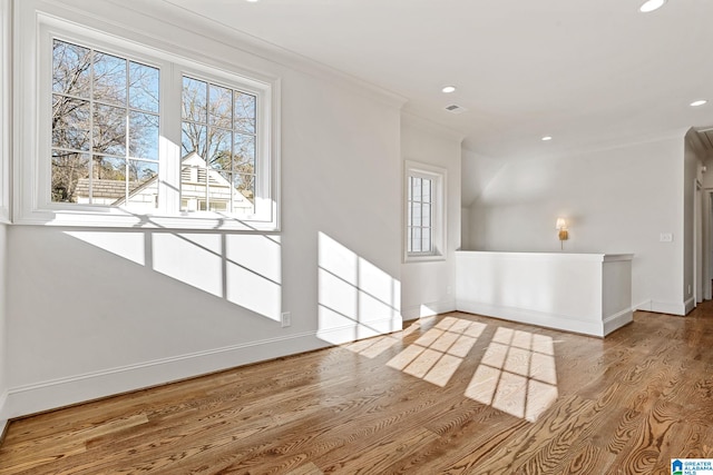 unfurnished living room featuring ornamental molding and light wood-type flooring