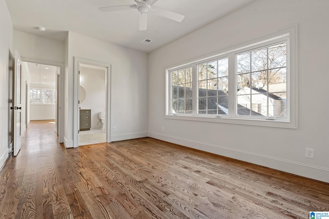 spare room featuring hardwood / wood-style floors and ceiling fan