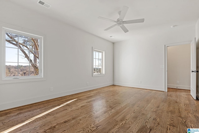 empty room featuring hardwood / wood-style floors and ceiling fan