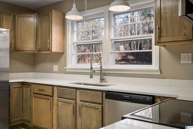 kitchen featuring appliances with stainless steel finishes, pendant lighting, and sink