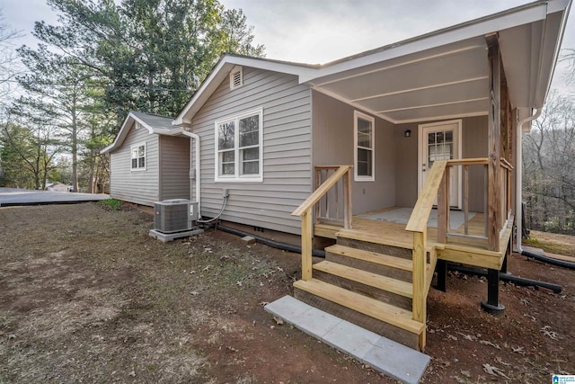 rear view of property featuring cooling unit