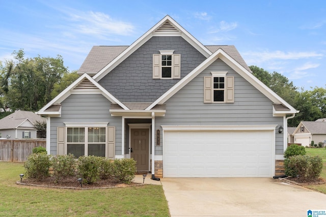 view of front of property featuring a front yard and a garage