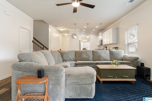 living room featuring ceiling fan and ornamental molding