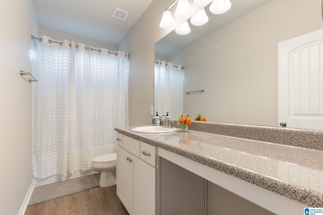 bathroom featuring toilet, hardwood / wood-style floors, and vanity