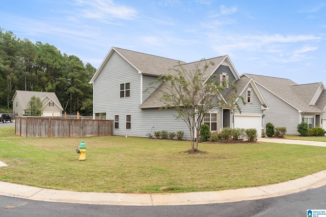 view of front of house with a garage and a front lawn