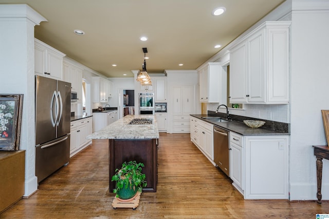 kitchen with sink, white cabinetry, and stainless steel appliances